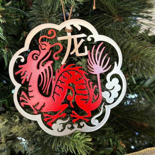 the dragon ornament is on a Christmas tree