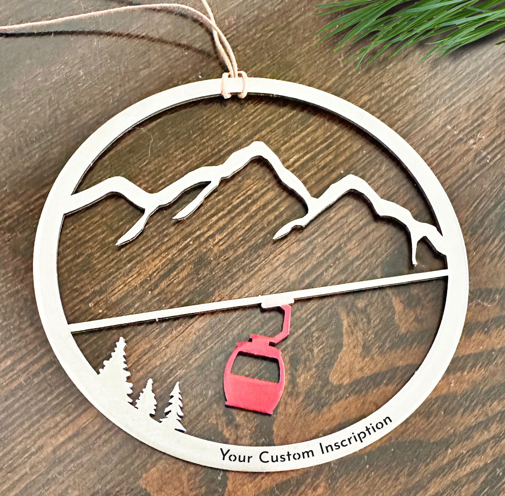 a wooden ornament with a ski lift on it