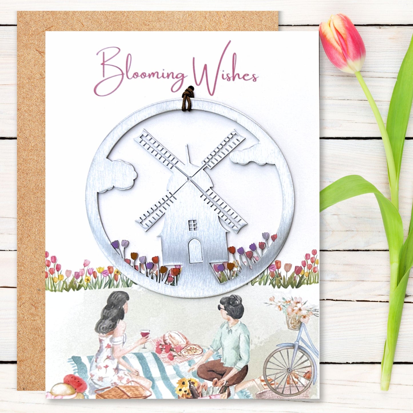a card with a picture of a windmill and two people