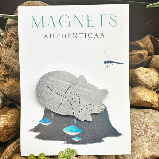fox sleeping magnet made of stainless steel, placed on an illustrated card