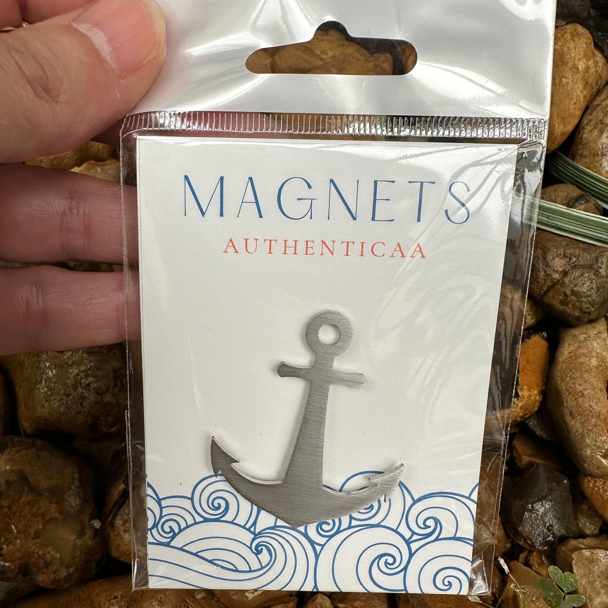 Anchor magnet made of stainless steel placed on an illustrated eco friendly card and in a plastic pouch